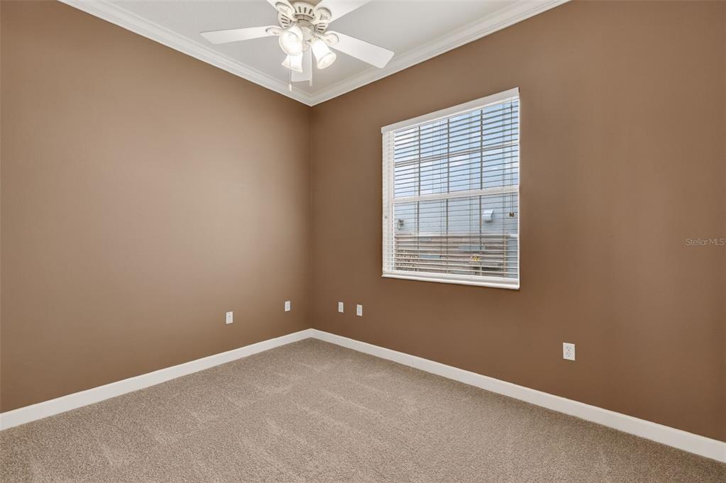 2117 Appalachee Circle Tavares, FL 32778 - Photo 18 of 30 an empty room with windows and chandelier fan