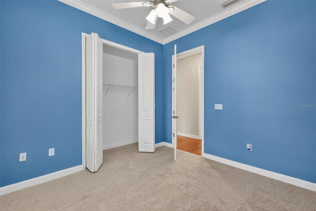 2117 Appalachee Circle Tavares, FL 32778 - Photo 19 of 30 an empty room with a chandelier fan and a window