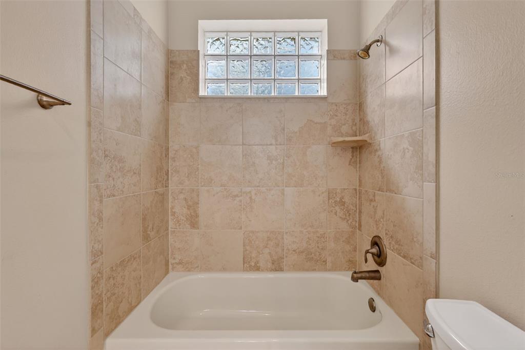 2117 Appalachee Circle Tavares, FL 32778 - Photo 21 of 30 a bath tub sitting next to a white toilet