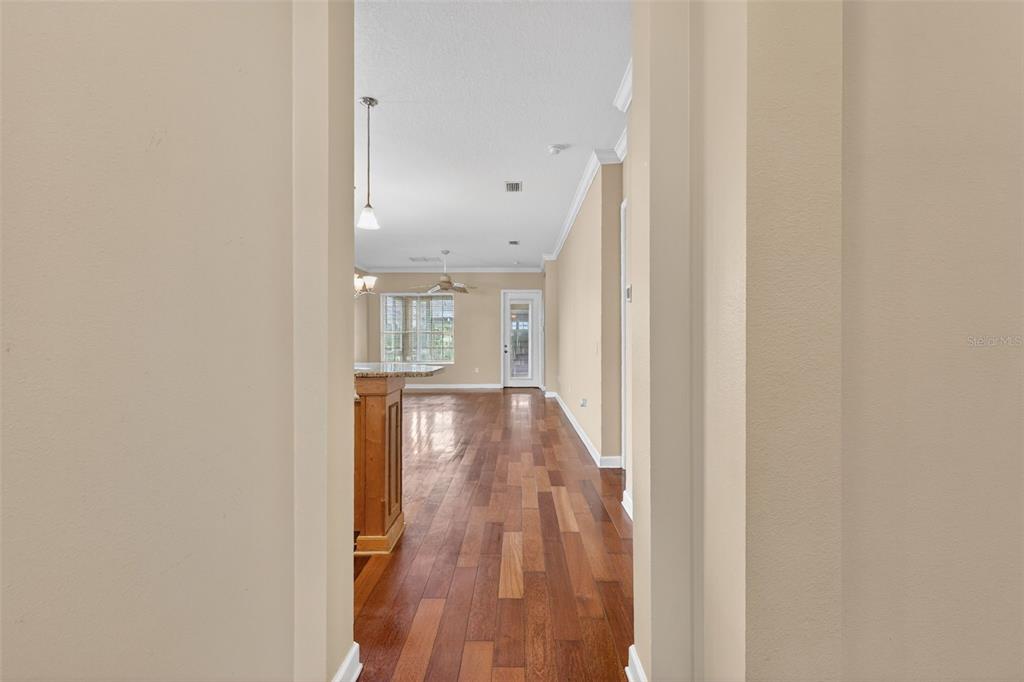 2117 Appalachee Circle Tavares, FL 32778 - Photo 3 of 30 a view of a hallway with wooden floor and cabinet