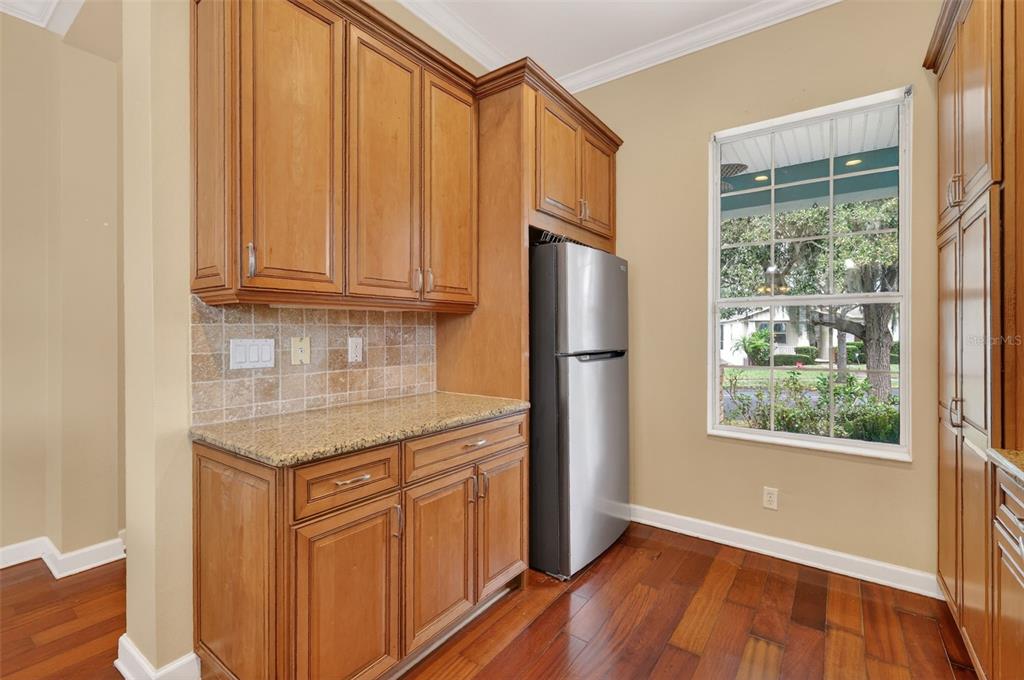 2117 Appalachee Circle Tavares, FL 32778 - Photo 8 of 30 a kitchen with stainless steel appliances granite countertop a refrigerator a sink and dishwasher with wooden floor