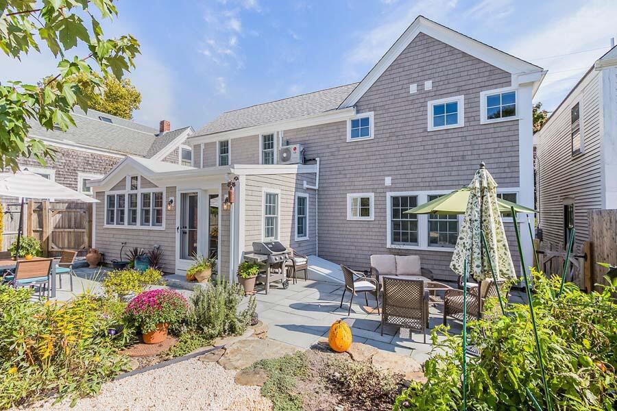 180 Commercial Street Wellfleet, MA 02667 - Photo 1 of 41 a front view of a house with outdoor seating