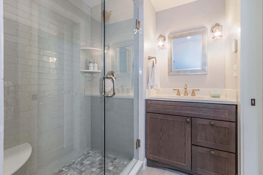 180 Commercial Street Wellfleet, MA 02667 - Photo 16 of 41 a bathroom with a granite countertop sink a mirror and a shower