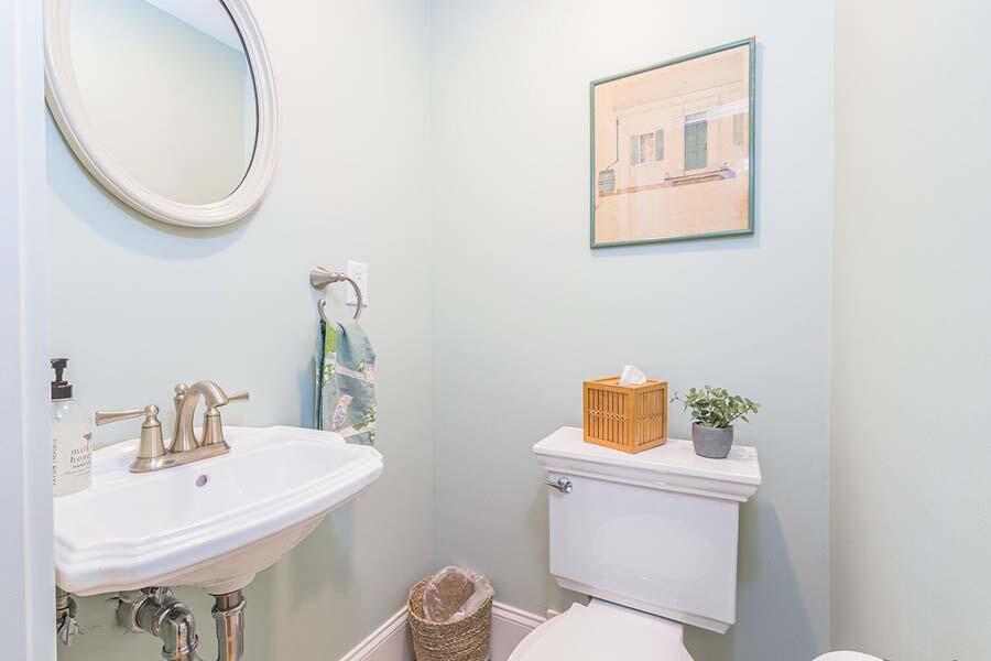 180 Commercial Street Wellfleet, MA 02667 - Photo 17 of 41 a bathroom with a sink a toilet and a mirror