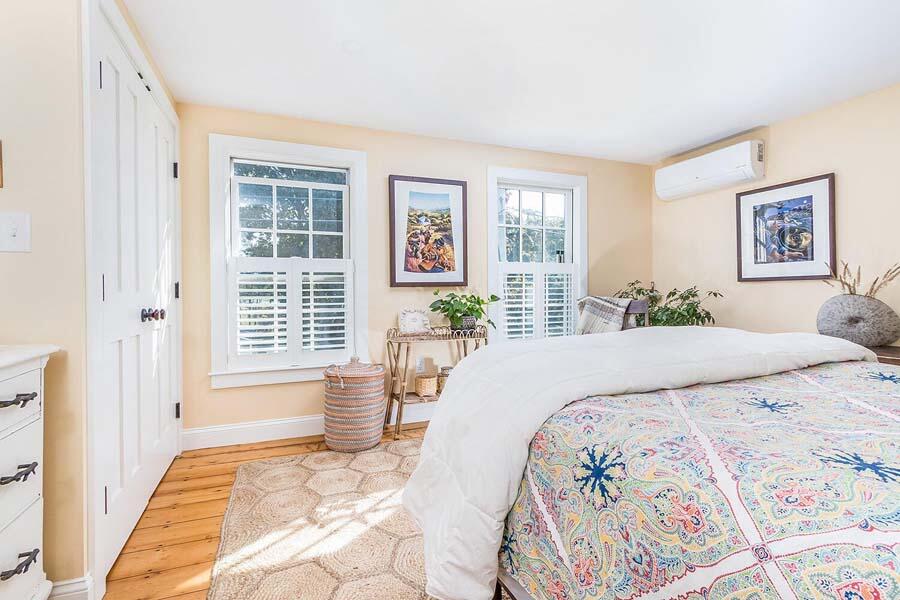 180 Commercial Street Wellfleet, MA 02667 - Photo 19 of 41 a bedroom with a large bed and a window