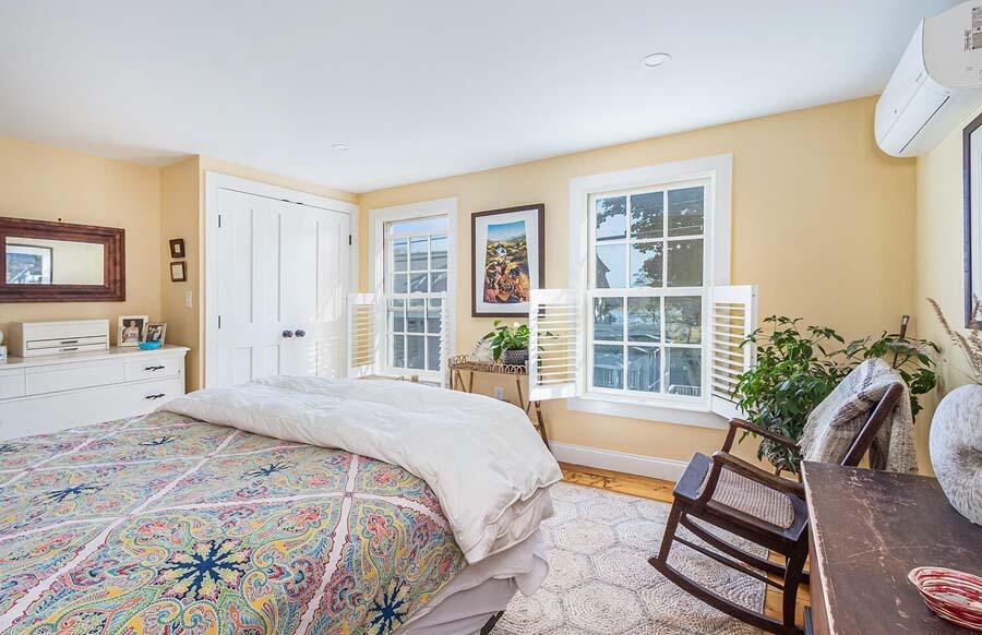 180 Commercial Street Wellfleet, MA 02667 - Photo 20 of 41 a spacious bedroom with a large bed and a large window