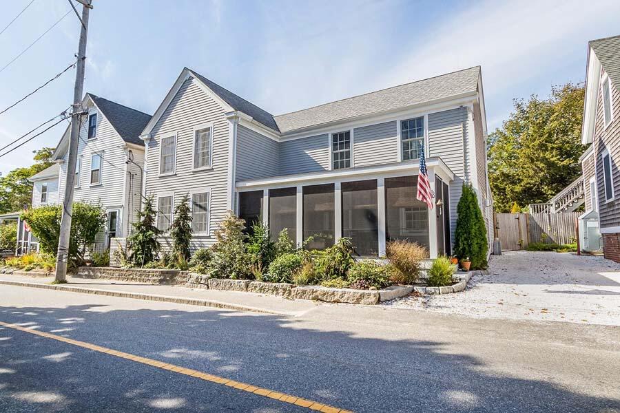 180 Commercial Street Wellfleet, MA 02667 - Photo 2 of 41 a front view of a house with a garden