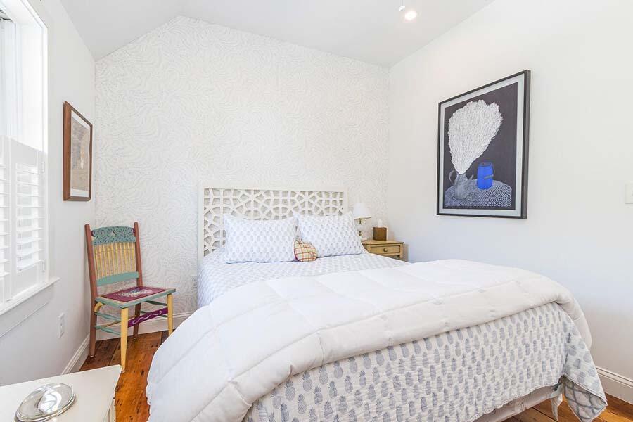 180 Commercial Street Wellfleet, MA 02667 - Photo 22 of 41 a bedroom with a bed and a painting on the wall