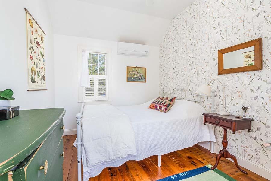 180 Commercial Street Wellfleet, MA 02667 - Photo 24 of 41 a bedroom with a bed and a table in it