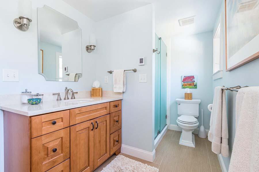 180 Commercial Street Wellfleet, MA 02667 - Photo 26 of 41 a spacious bathroom with a granite countertop toilet sink and a mirror