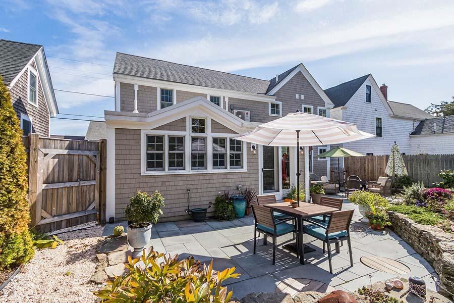 180 Commercial Street Wellfleet, MA 02667 - Photo 34 of 41 a patio with a table and chairs under an umbrella