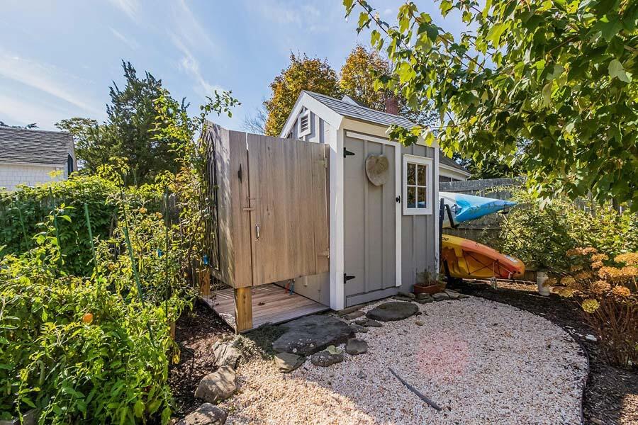 180 Commercial Street Wellfleet, MA 02667 - Photo 37 of 41 a view of a house with a yard and a tree