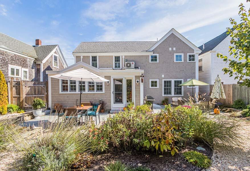 180 Commercial Street Wellfleet, MA 02667 - Photo 38 of 41 a front view of a house with a yard