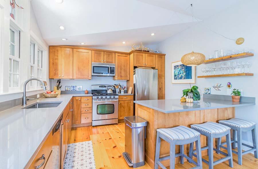 180 Commercial Street Wellfleet, MA 02667 - Photo 5 of 41 a kitchen with stainless steel appliances granite countertop a sink and a refrigerator