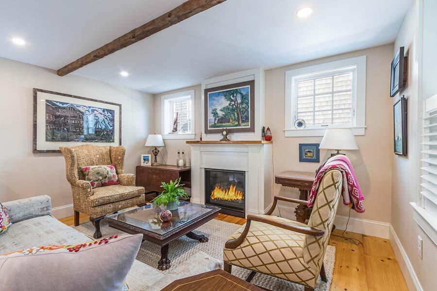 180 Commercial Street Wellfleet, MA 02667 - Photo 9 of 41 a living room with furniture and a fireplace