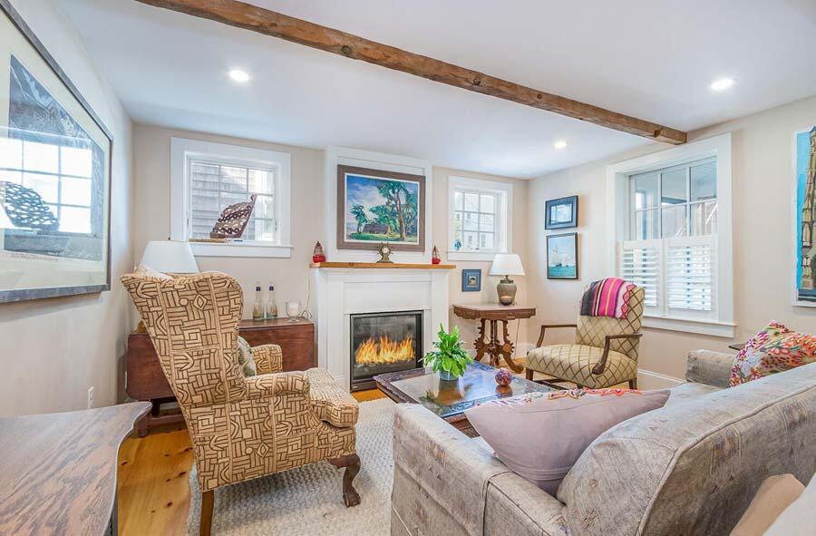 180 Commercial Street Wellfleet, MA 02667 - Photo 10 of 41 a living room with furniture and a fireplace