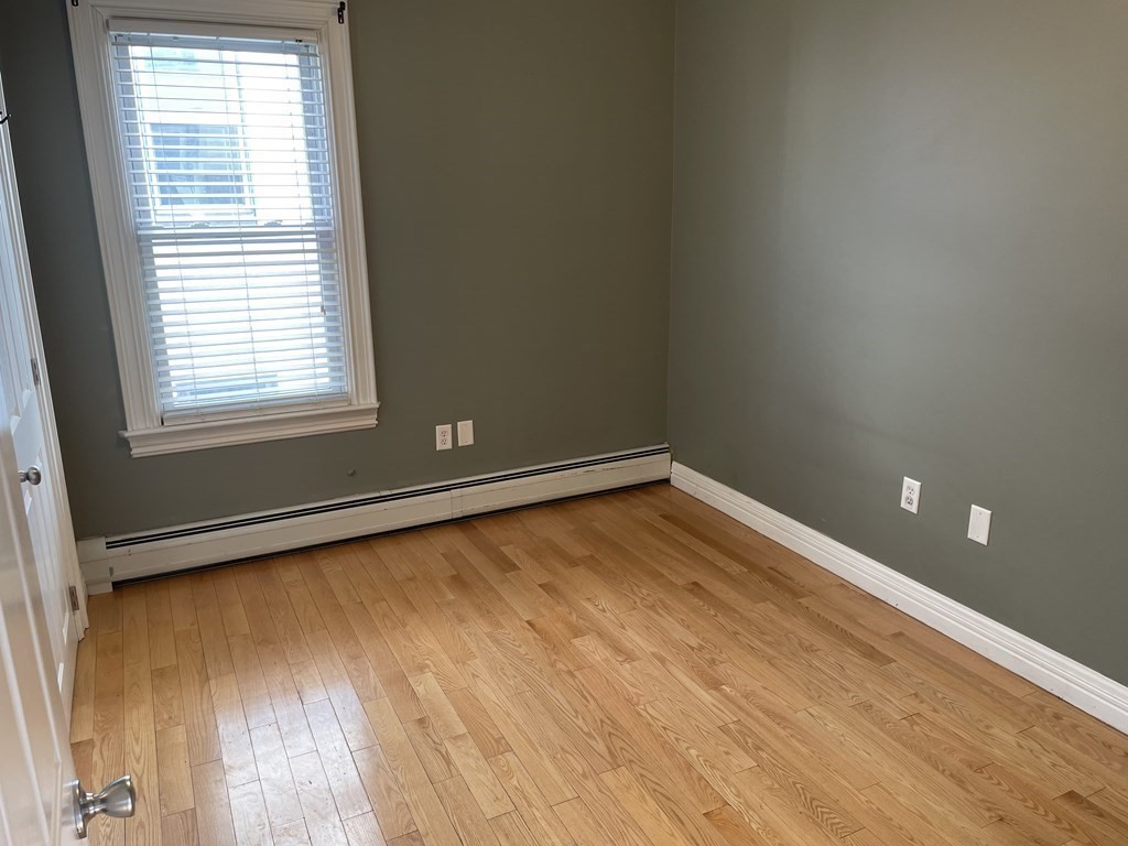 503 William Street Fall River, MA 02721 - Photo 5 of 19 a view of a room with wooden floor and a window