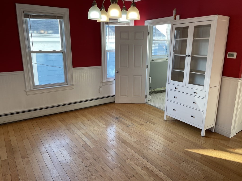 503 William Street Fall River, MA 02721 - Photo 6 of 19 a view of an empty room with a window and wooden floor