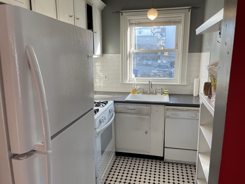 503 William Street Fall River, MA 02721 - Photo 8 of 19 a bathroom with a sink a window and a shower