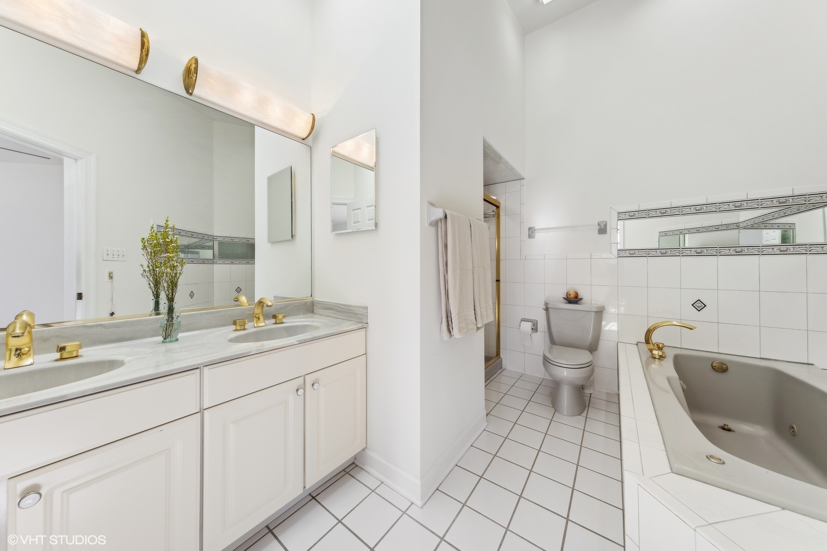 731 South Racine Avenue, Unit B Chicago, IL 60607 - Photo 17 of 29 a spacious bathroom with a granite countertop sink mirror vanity and toilet