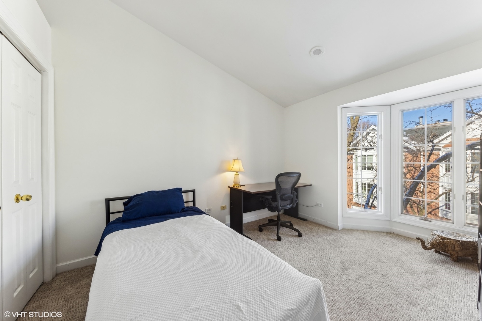 731 South Racine Avenue, Unit B Chicago, IL 60607 - Photo 19 of 29 a bedroom with a bed table chair and two windows