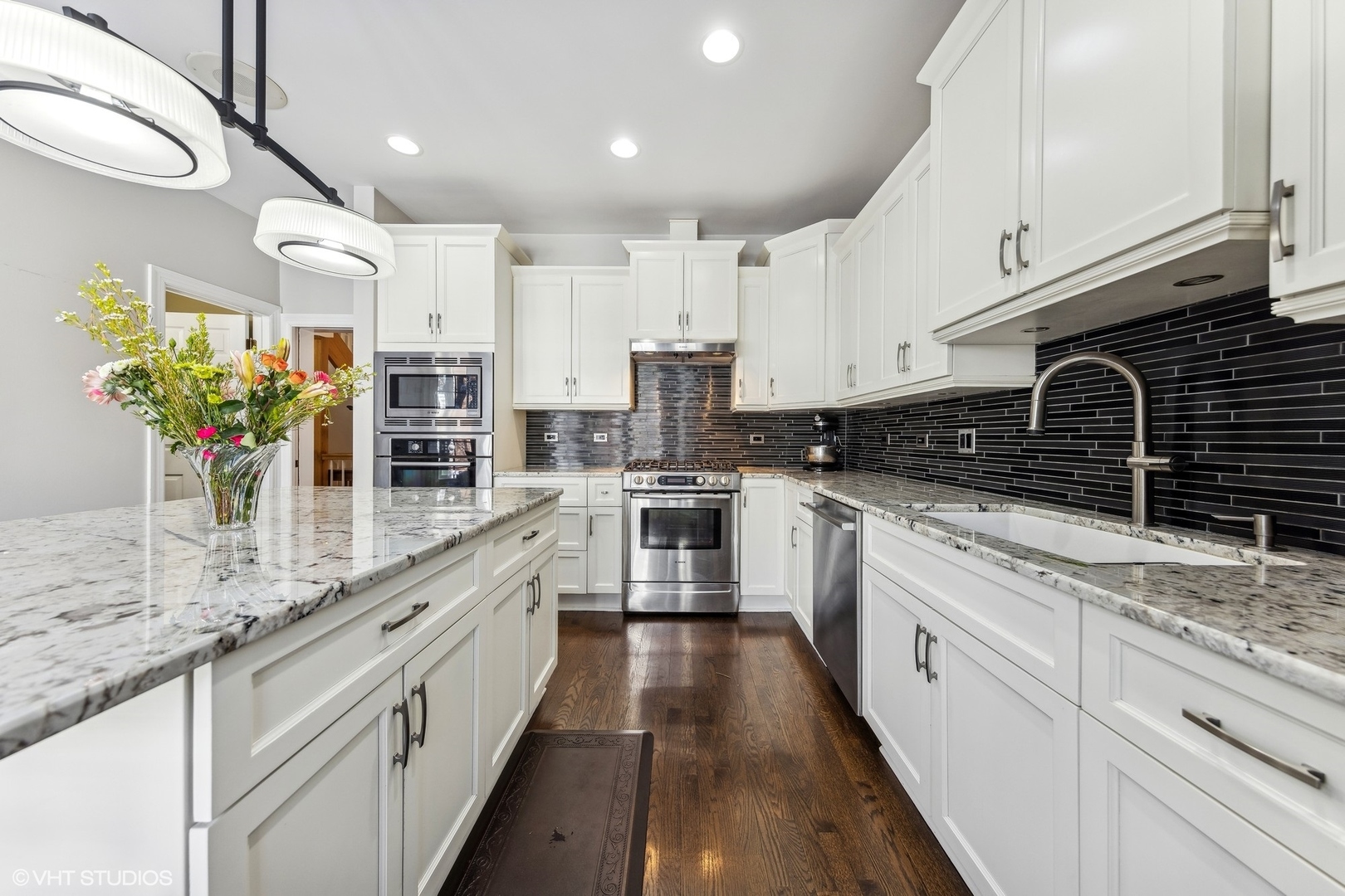 731 South Racine Avenue, Unit B Chicago, IL 60607 - Photo 8 of 29 a large kitchen with stainless steel appliances granite countertop a lot of counter space and wooden floors