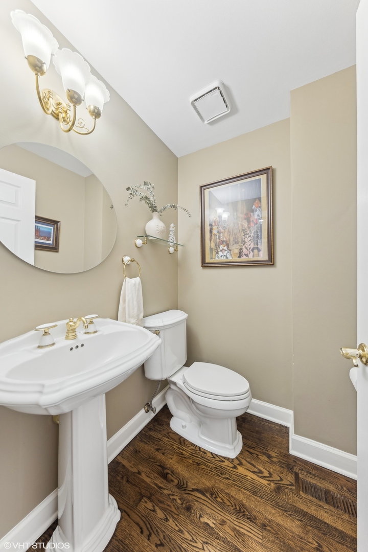731 South Racine Avenue, Unit B Chicago, IL 60607 - Photo 10 of 29 a bathroom with a sink a toilet and mirror