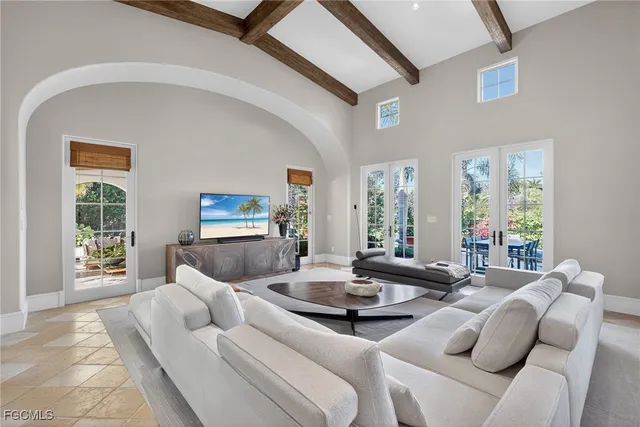 a living room with furniture gym equipment and a large window