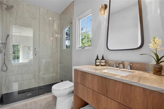 a bathroom with a sink a toilet and a mirror