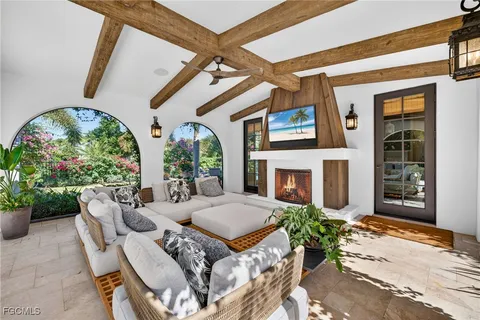 a outdoor living space with furniture potted plant and a fireplace