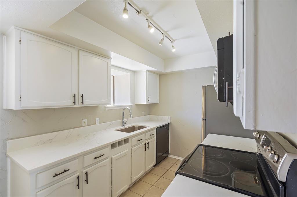 4523 North O'Connor Road, Unit 1177 Irving, TX 75062 - Photo 18 of 31 a kitchen with a sink and cabinets