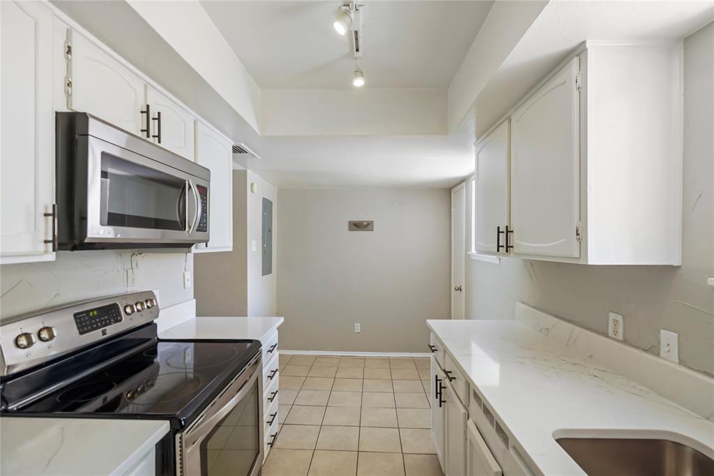 4523 North O'Connor Road, Unit 1177 Irving, TX 75062 - Photo 21 of 31 a kitchen that has a sink and a stove in it