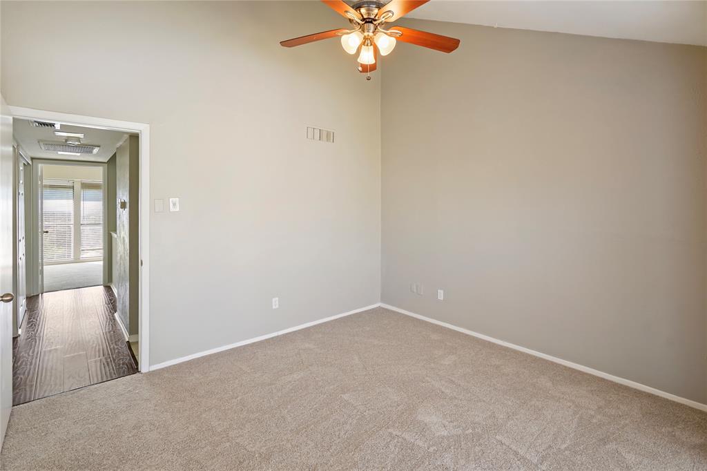 4523 North O'Connor Road, Unit 1177 Irving, TX 75062 - Photo 27 of 31 an empty room with a chandelier fan and windows