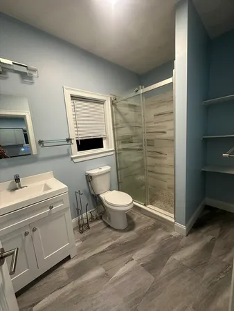 a bathroom with a toilet sink and shower