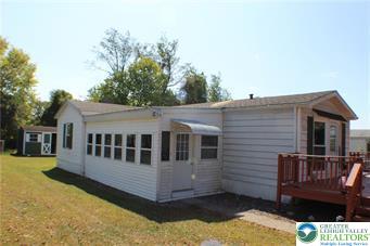 222 Independence Way Mount Bethel, PA 18343 - Photo 2 of 33 a view of a house with wooden walls and a yard