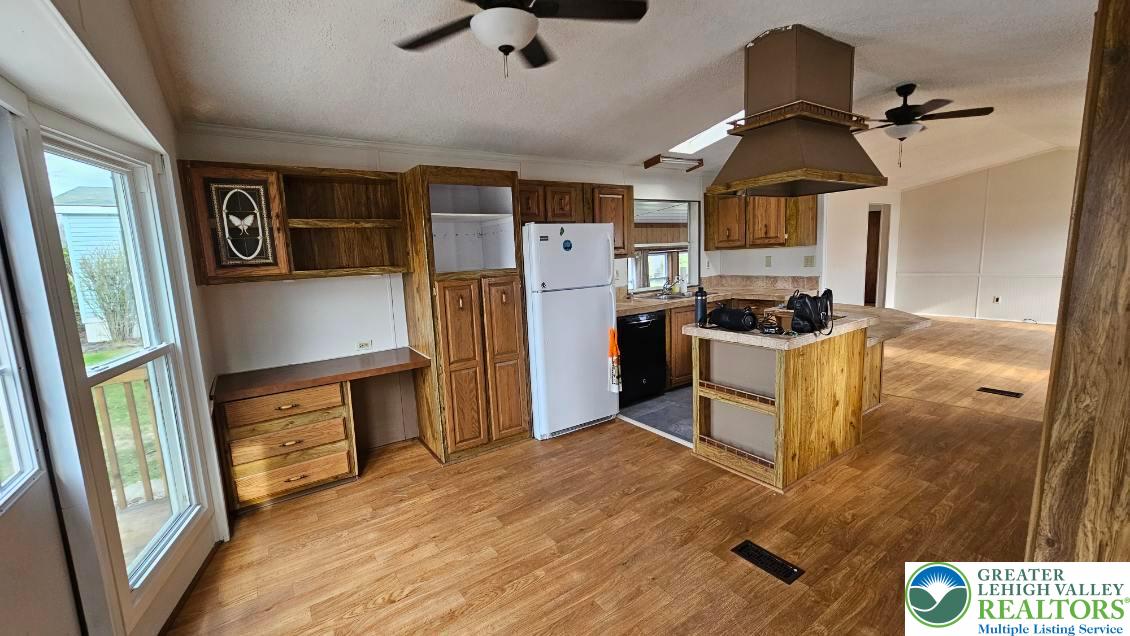 222 Independence Way Mount Bethel, PA 18343 - Photo 7 of 33 a kitchen with stainless steel appliances granite countertop a refrigerator a stove a sink dishwasher and white cabinets with wooden floor
