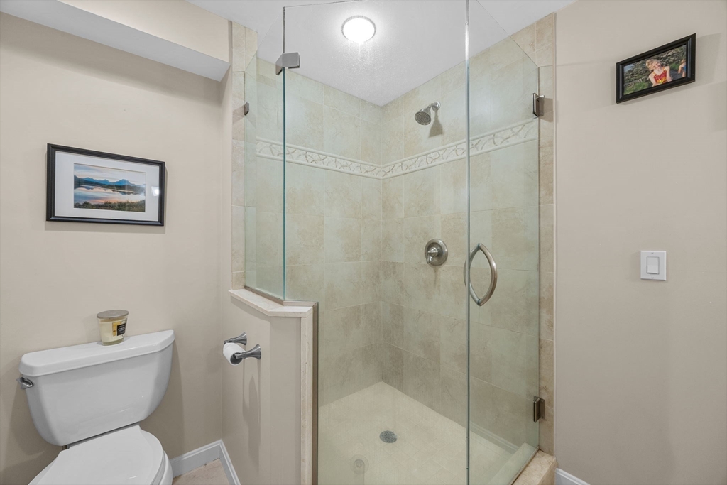 381 Great Oak Road, Unit 9 Mashpee, MA 02649 - Photo 22 of 42 a bathroom with a toilet and a shower