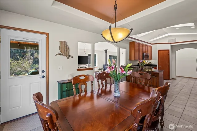 a view of a dining room with furniture and chandelier