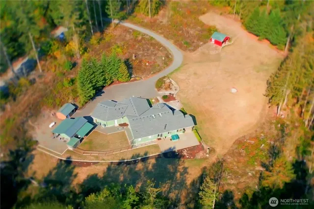 an aerial view of a house with yard