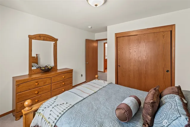 a bedroom with a bed and a dresser