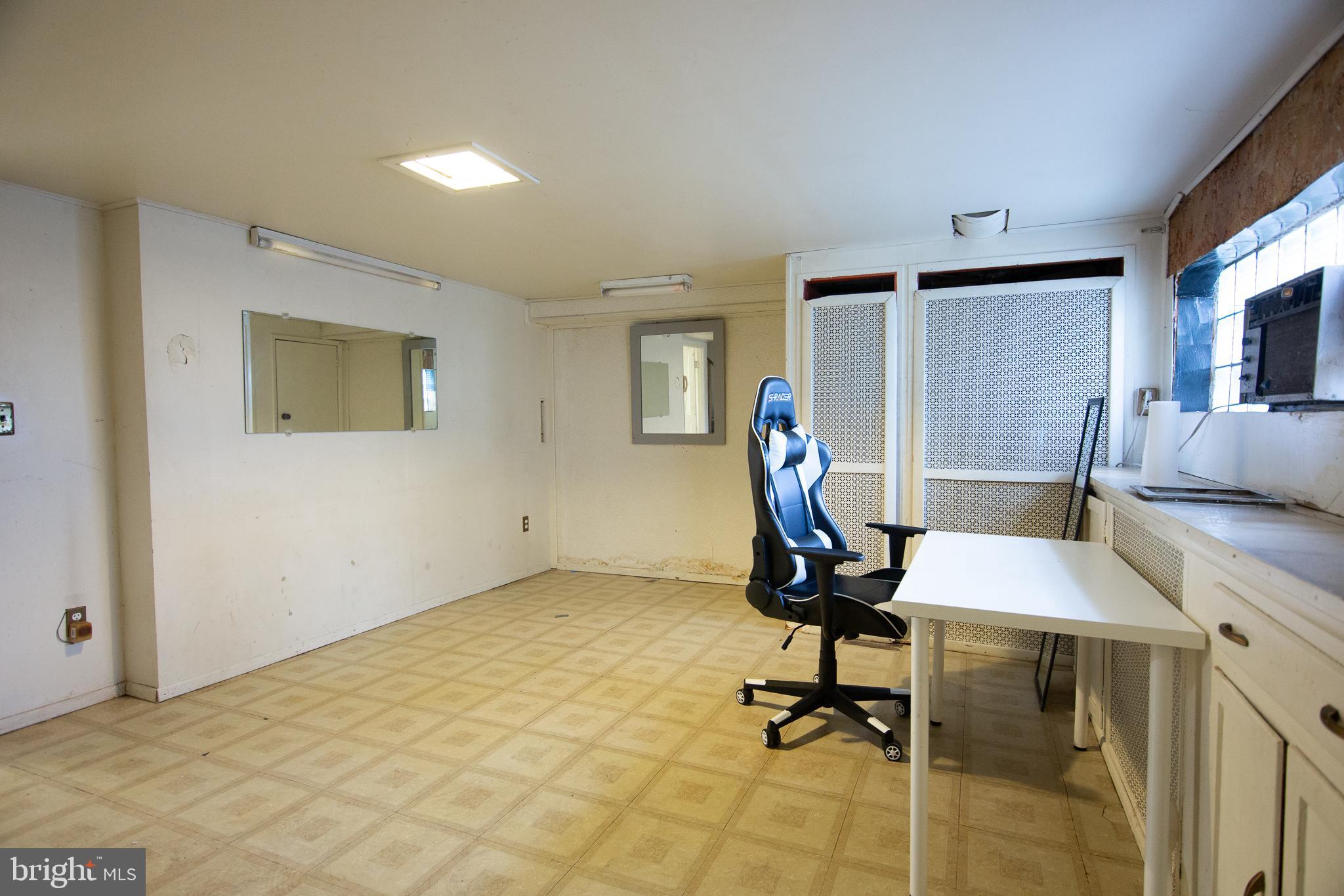 7617 Woolston Avenue Philadelphia, PA 19150 - Photo 11 of 24 a view of a workspace with furniture and a window