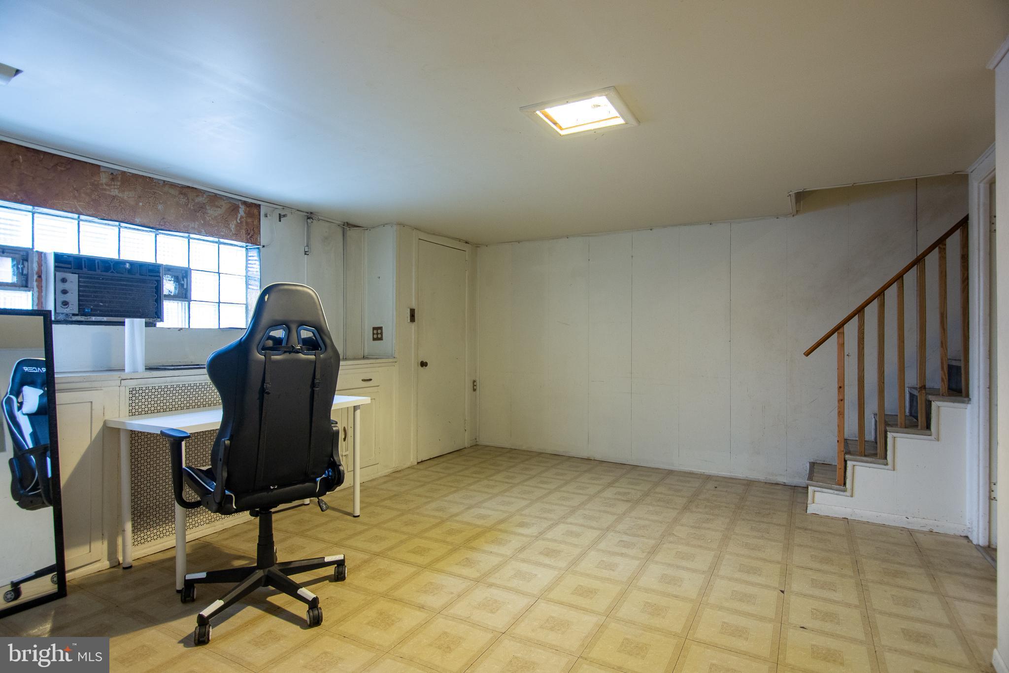 7617 Woolston Avenue Philadelphia, PA 19150 - Photo 12 of 24 a view of a workspace with furniture and windows