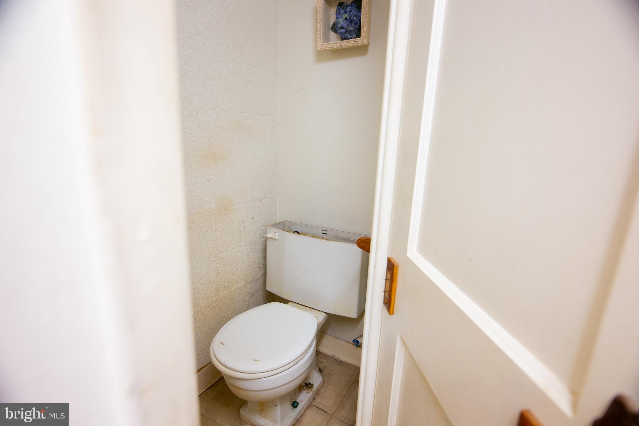 7617 Woolston Avenue Philadelphia, PA 19150 - Photo 13 of 24 a white toilet sitting next to a white cabinet