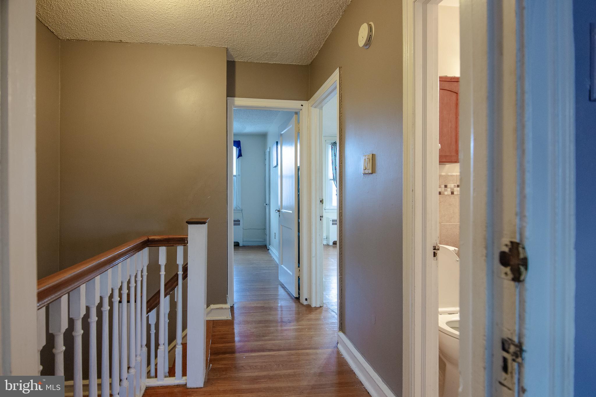 7617 Woolston Avenue Philadelphia, PA 19150 - Photo 16 of 24 a view of a hallway with wooden floor