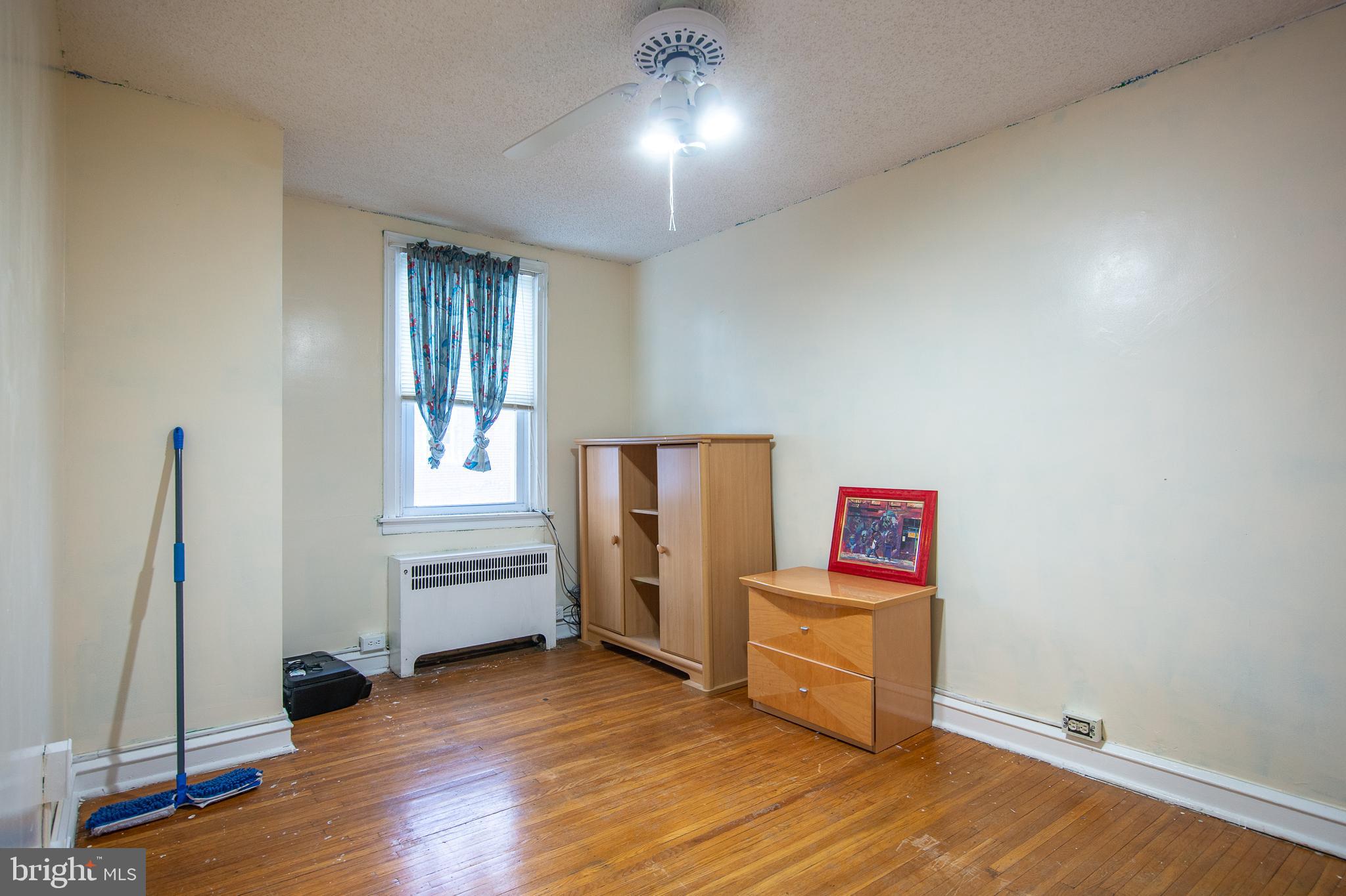 7617 Woolston Avenue Philadelphia, PA 19150 - Photo 21 of 24 an empty room with wooden floor and windows