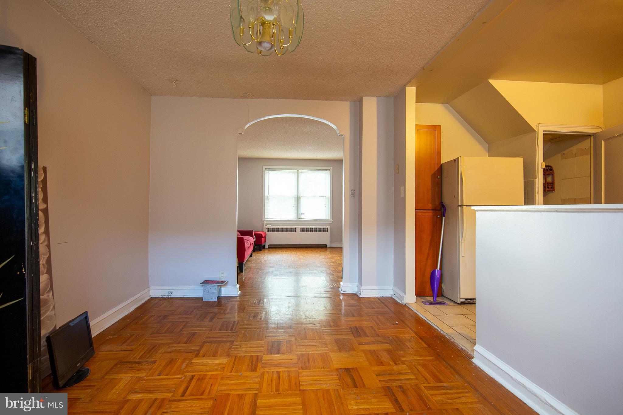 7617 Woolston Avenue Philadelphia, PA 19150 - Photo 4 of 24 a view of a livingroom with wooden floor and a chandelier