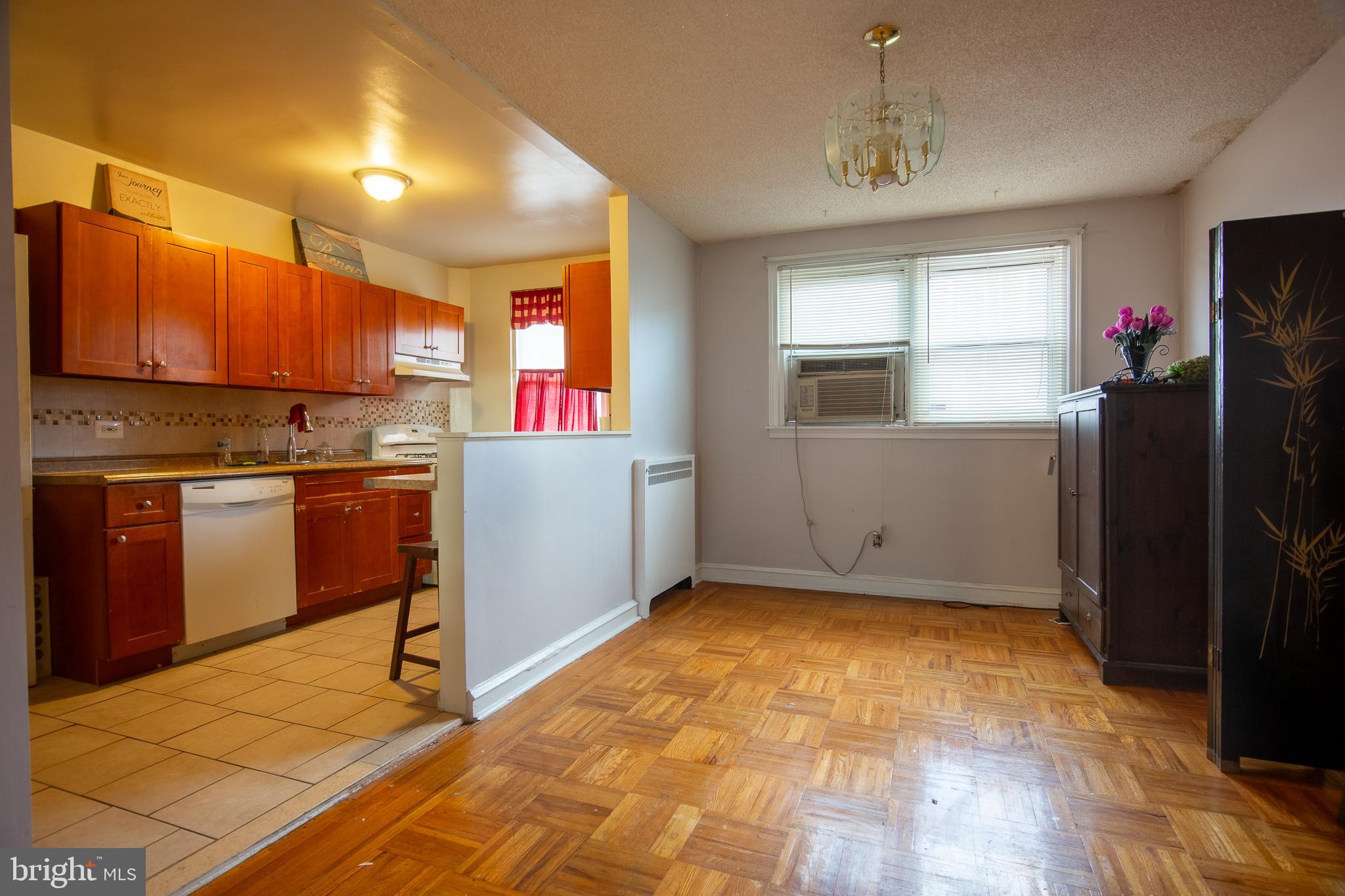 7617 Woolston Avenue Philadelphia, PA 19150 - Photo 5 of 24 a kitchen with a refrigerator sink and cabinets