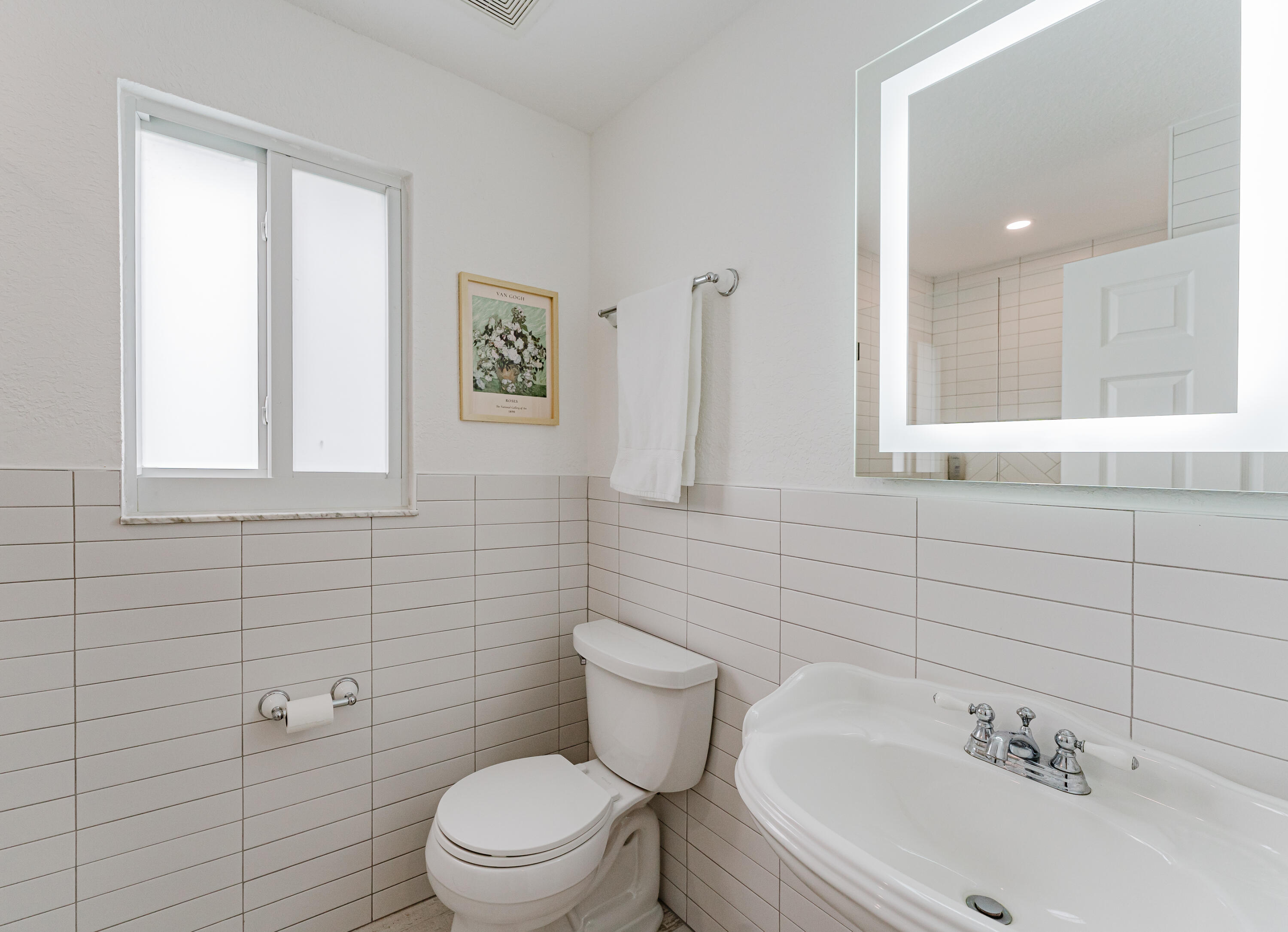 921 Ortega Road West Palm Beach, FL 33405 - Photo 22 of 60 a bathroom with a sink a toilet and a mirror