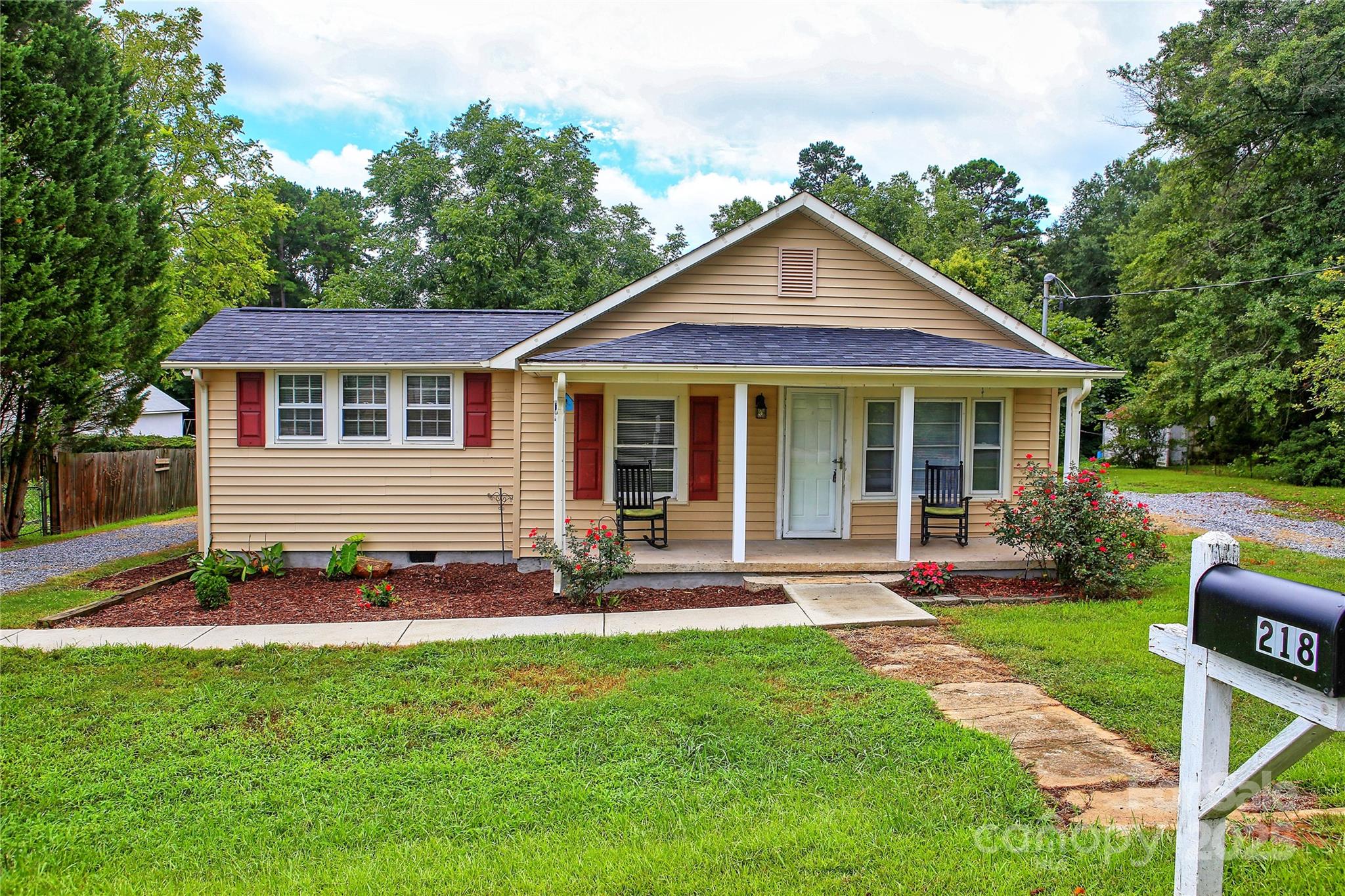 218 Blacksnake Road Stanley, NC 28164 - Photo 1 of 36 a front view of a house with a yard and trees