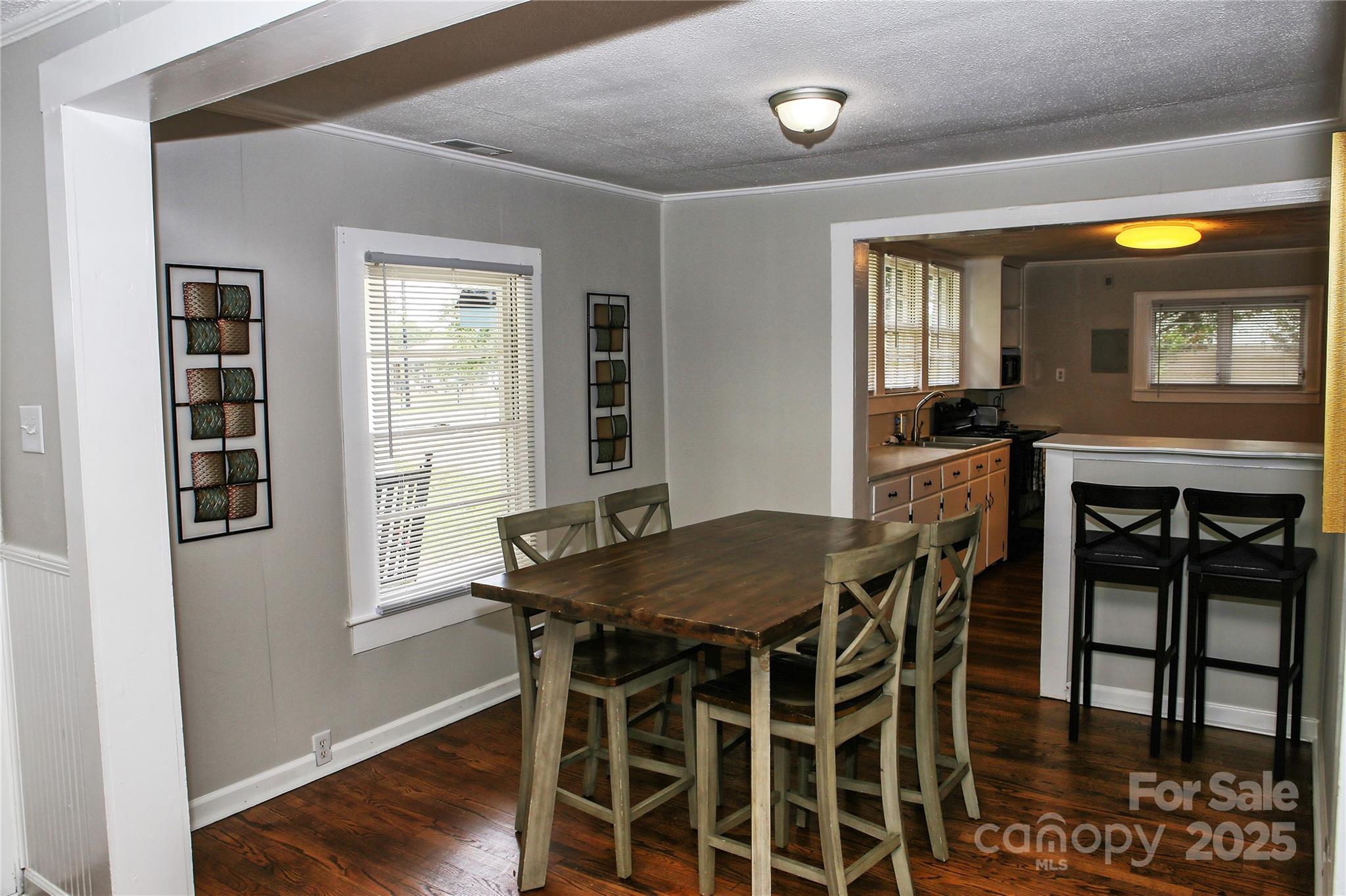 218 Blacksnake Road Stanley, NC 28164 - Photo 13 of 36 a view of a dining room with furniture and wooden floor